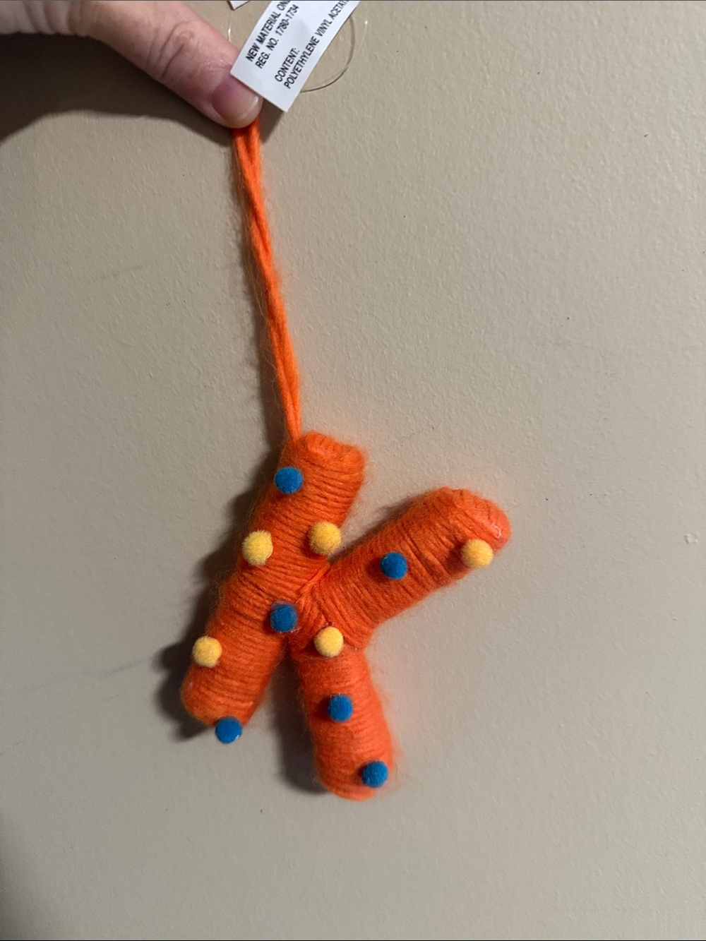 Ashland Orange Yarn Letter K Hanging Plush with Blue and Yellow Poms